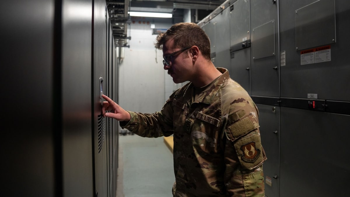 Data center operator checking a critical uninterruptible power supply