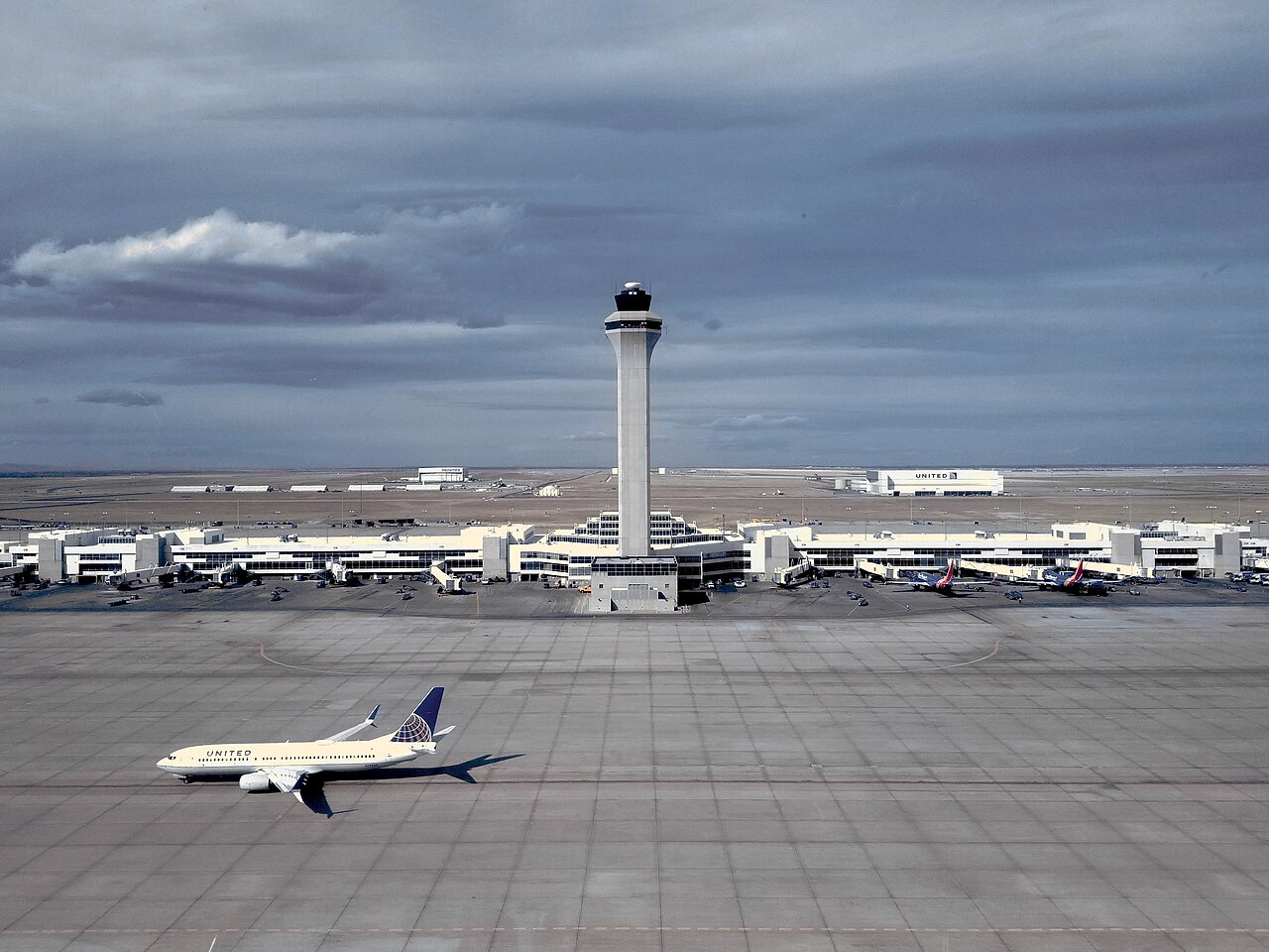 United Airlines aircraft below the air traffic control tower at Denver International Airport in 2018.