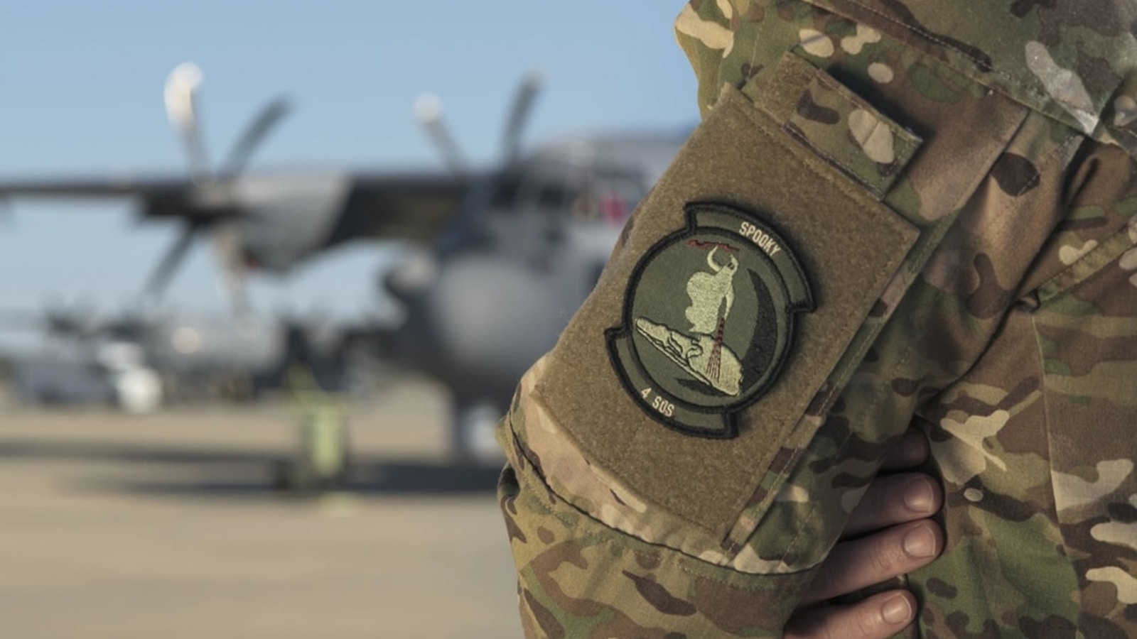Air Force sensor operator near an aircraft