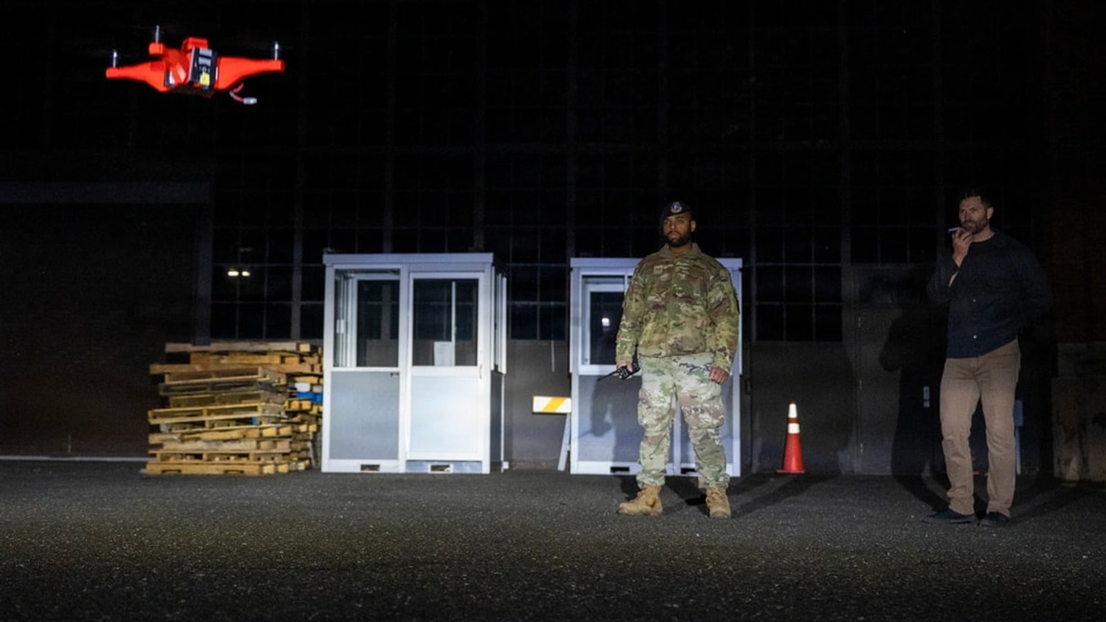 Military personnel observing a small unmanned aircraft during counter-drone testing