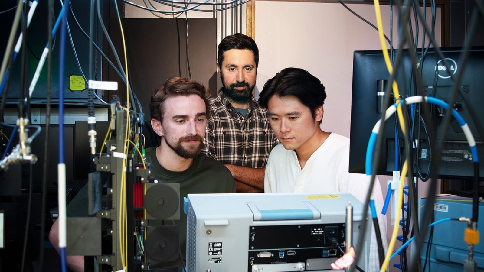 Erik Szakiel, Amir Safavi-Naeini and Takuma Makihara at the radio-frequency instrumentation used in their research