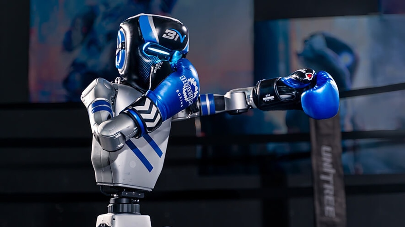 Unitree G1 robot in blue gloves extending a punch in a boxing ring