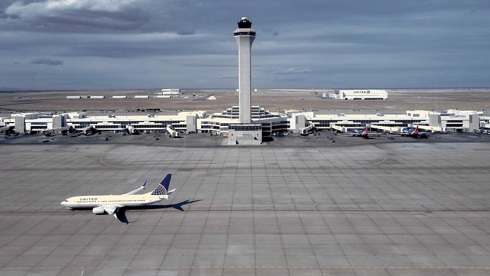 United Airlines aircraft below the air traffic control tower at Denver International Airport in 2018