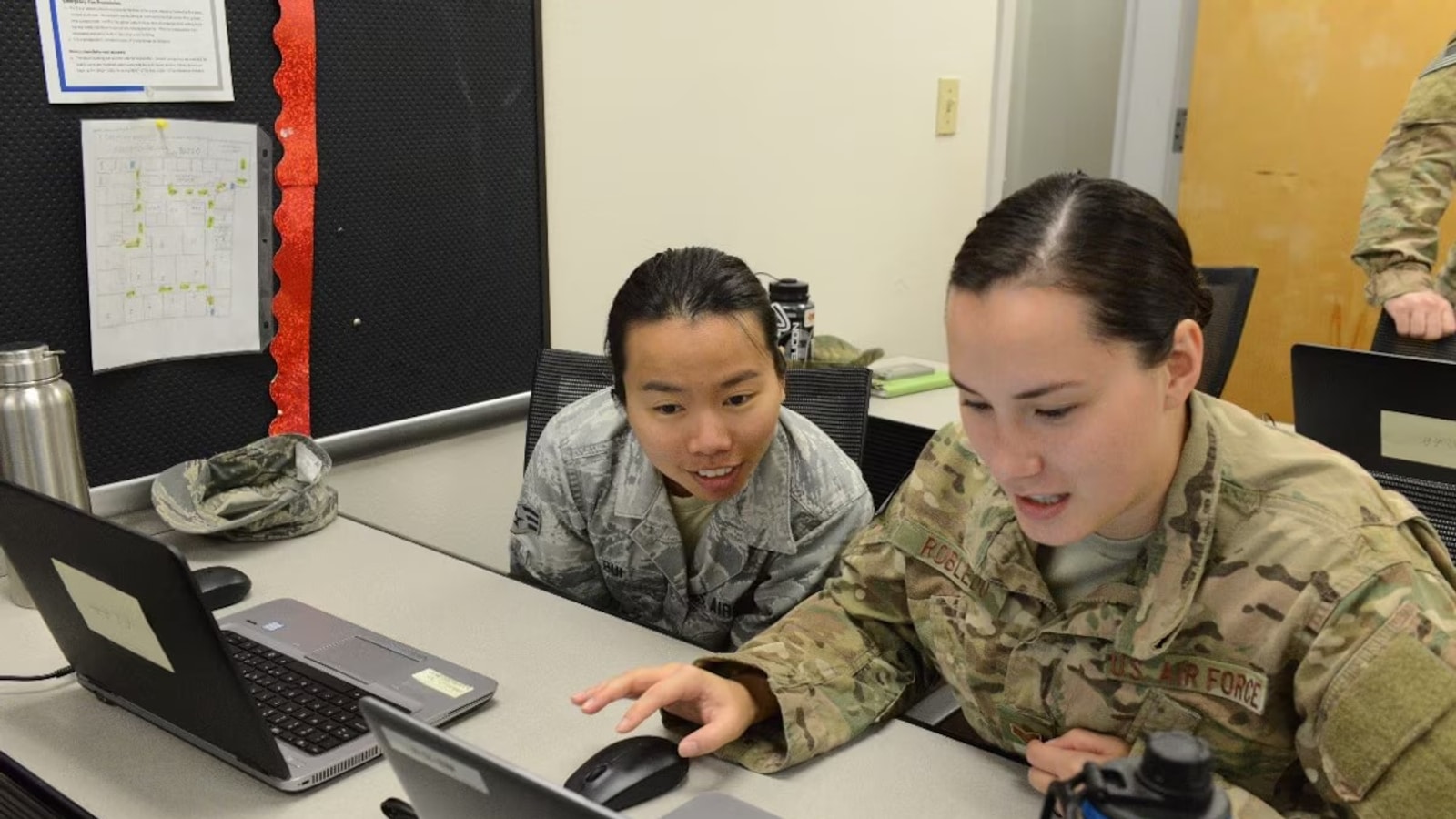 Two U.S. Air Force special operations intelligence analysts at an AI data-tagging session in 2017; contextual photo, not the reported ship incident