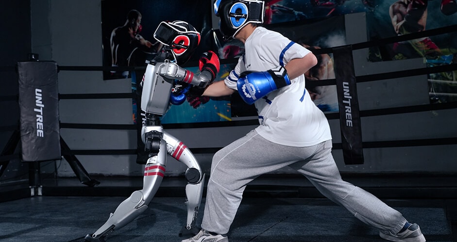 Human operator sparring with a Unitree G1 humanoid robot