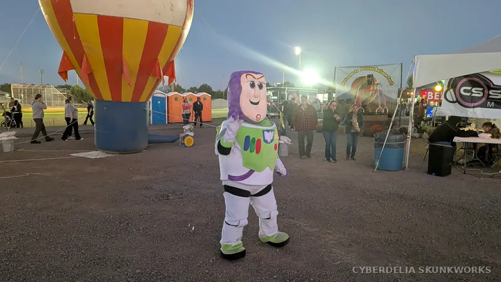 A Buzz Lightyear-costumed entertainer walks near the festival entrance.