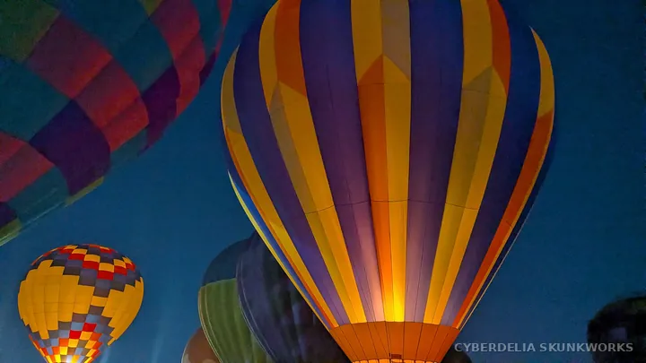 A striped envelope fills the frame above a smaller balloon.