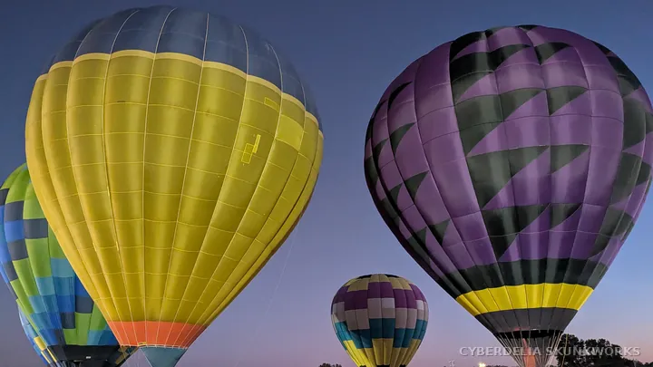 Yellow and purple envelopes reveal their fabric panels in burner light.