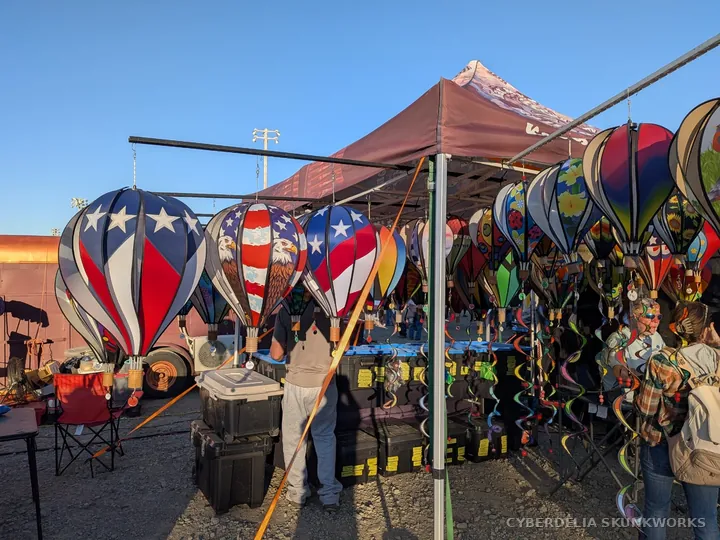 Balloon-shaped decorations hang from a vendor display.