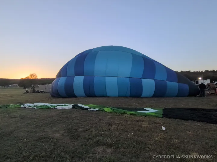 A blue envelope begins to fill while lying on the ground.