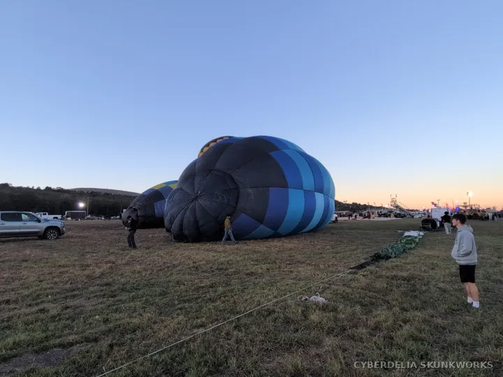 The mouth of a blue balloon faces its ground crew.