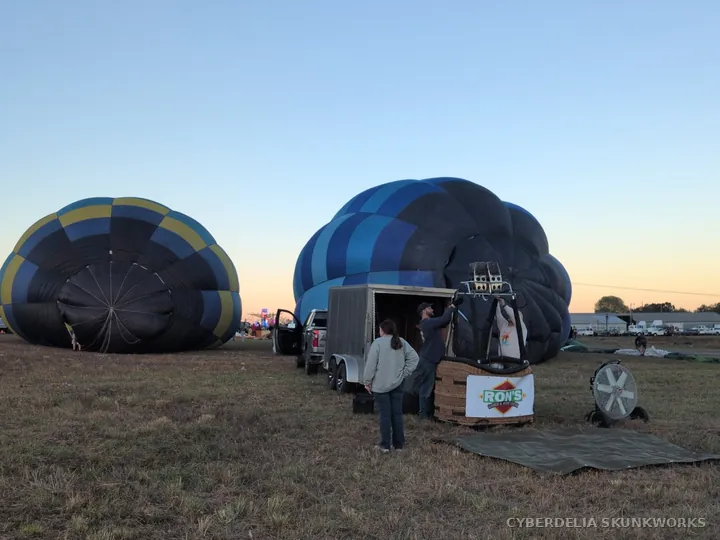 Crews work between partially inflated envelopes.