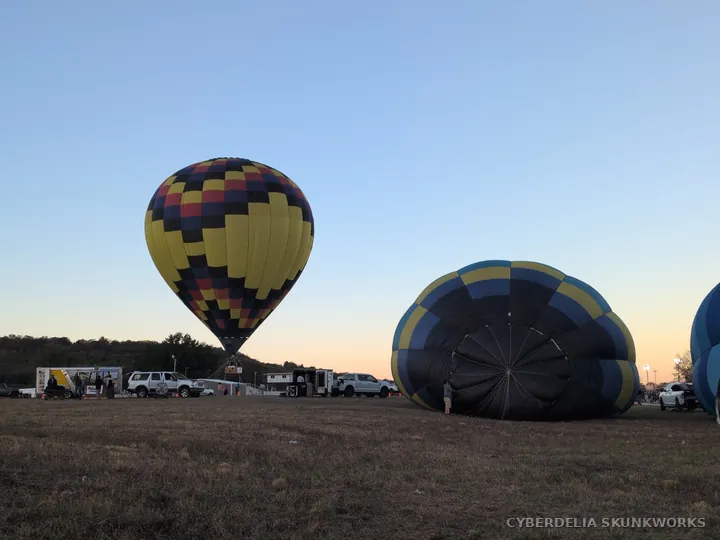 An upright balloon stands behind an envelope still taking shape.