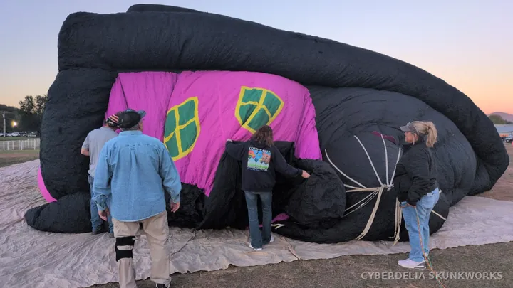 People and equipment show the scale of the fabric on the ground.
